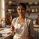 Portrait of pastry editor Meera Nair holding a wooden spoon in a sunlit kitchen